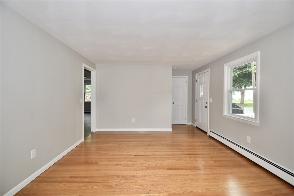94 David Street Springfield, MA 01104 - Photo 8 of 39 an empty room with wooden floor and windows