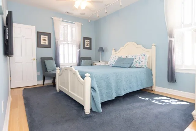 a bedroom with a bed chair and window