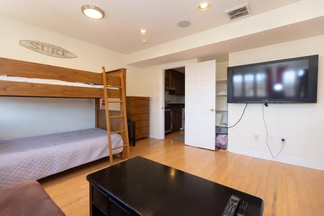 a bedroom with furniture and wooden floor