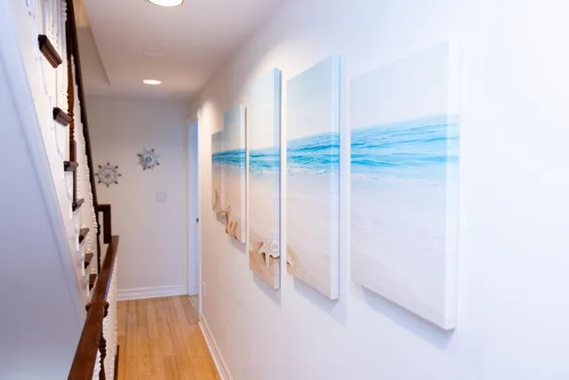 a view of a hallway with wooden floor and entryway