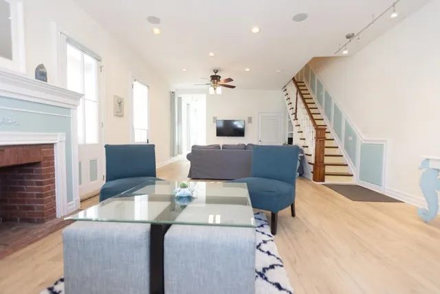 a living room with furniture and wooden floor