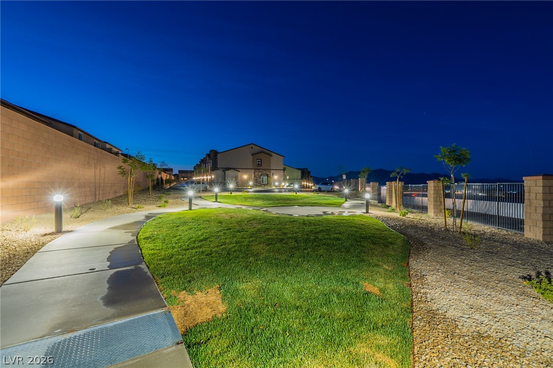 6444 Spring Jog Street Las Vegas, NV 89166 - Photo 12 of 13 Walk along this illuminated path through green spaces, leading to inviting residences.