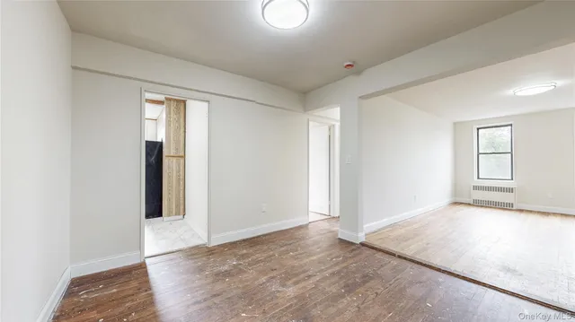 an empty room with windows and closet