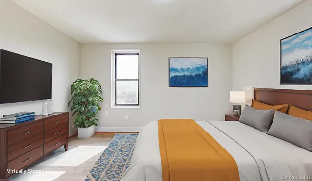 a bedroom with a bed and a flat screen tv