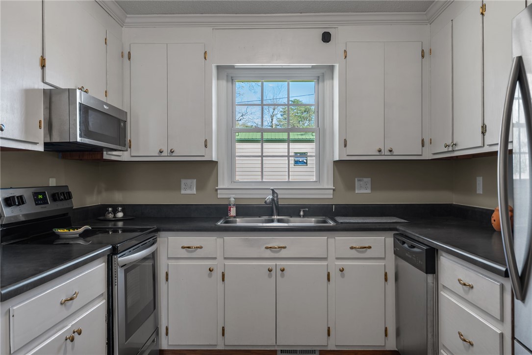 300 Green Street Williamston, SC 29697 - Photo 3 of 47 This efficient kitchen boasts modern appliances and ample storage, creating a functional cooking space.