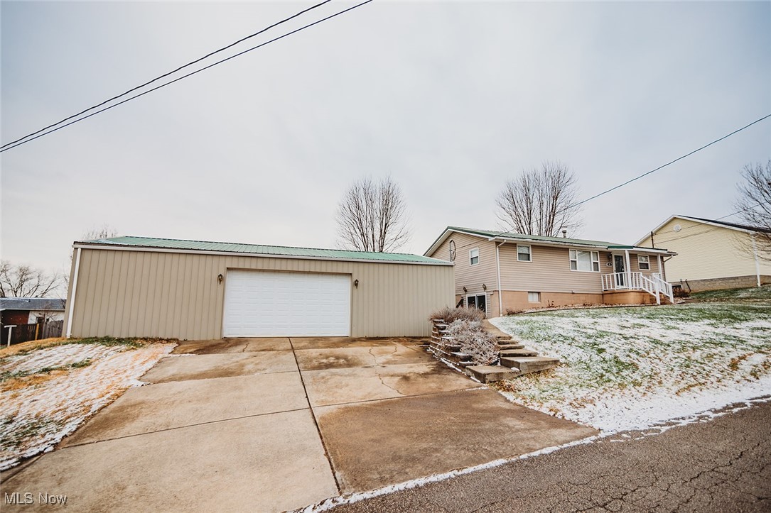 91 Mike Street Washington, WV 26181 - Photo 2 of 42 View of front of property featuring an outbuilding, a detached garage, and a metal roof