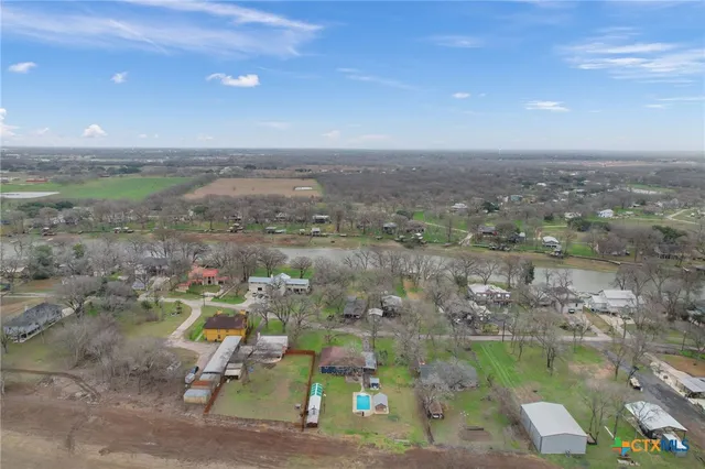 an aerial view of residential houses with outdoor space and river