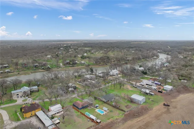 an aerial view of a residential houses with outdoor space