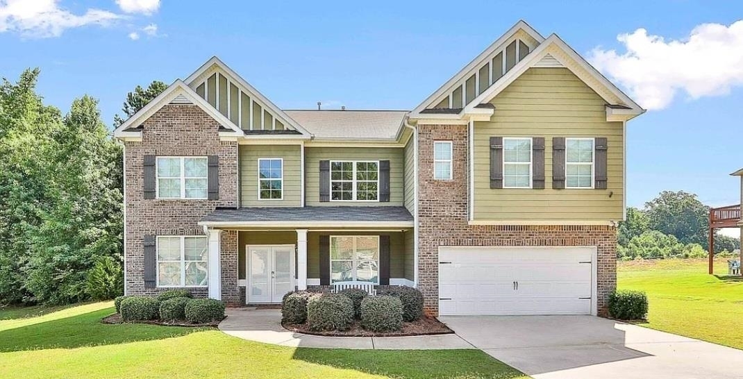 913 Damson Trail Hampton, GA 30228 - Photo 1 of 1 a front view of a house with a yard and garage