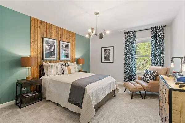 a bedroom with a bed couch and a window