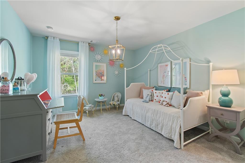 631 Treasure Drive Stockbridge, GA 30281 - Photo 22 of 33 a living room with furniture a table and a chandelier