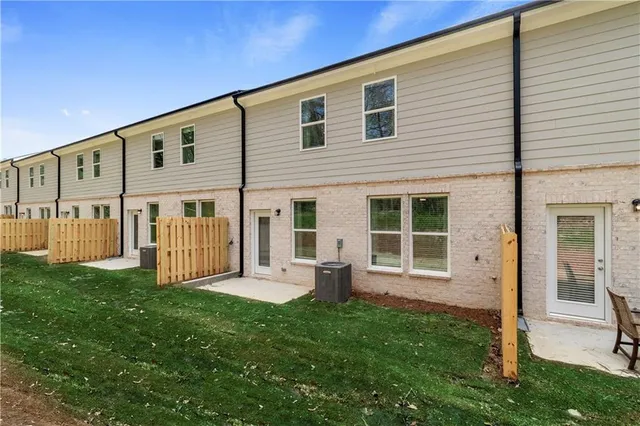 a view of a house with a yard and porch