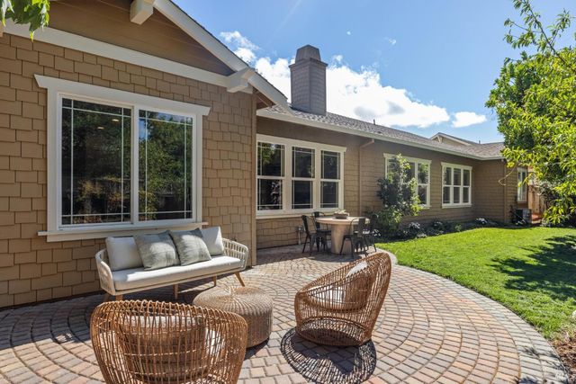 a view of a patio with couches chairs and potted plants