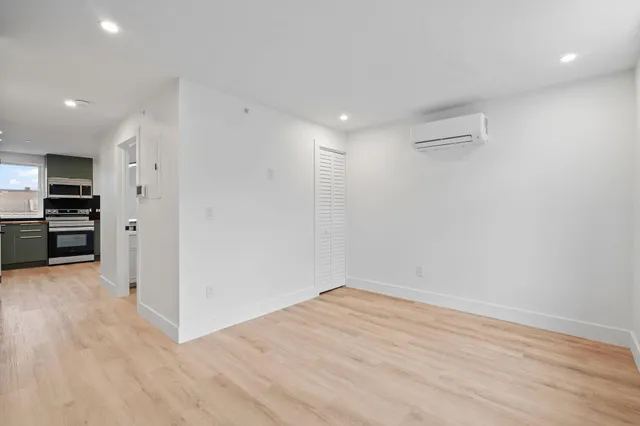 a view of empty room with wooden floor