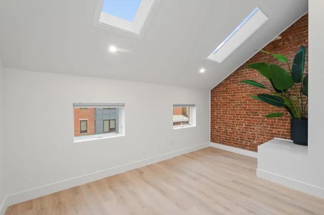 a view of an empty room with a window and a garage