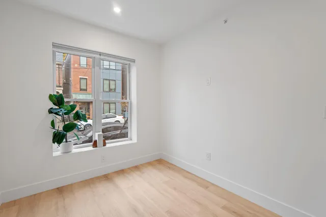 a view of an empty room and a window