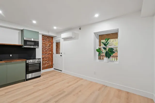 a kitchen with stainless steel appliances a refrigerator and a stove top oven