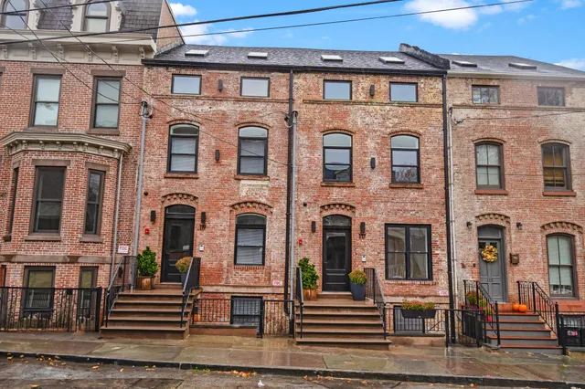 a front view of a building with many windows