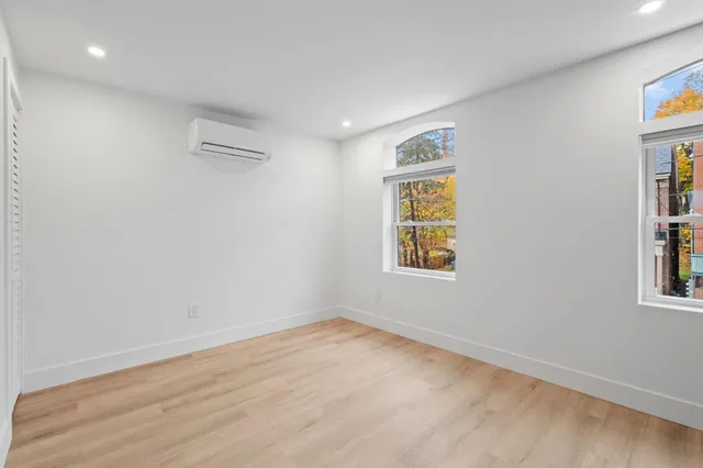 wooden floor in an empty room with a window