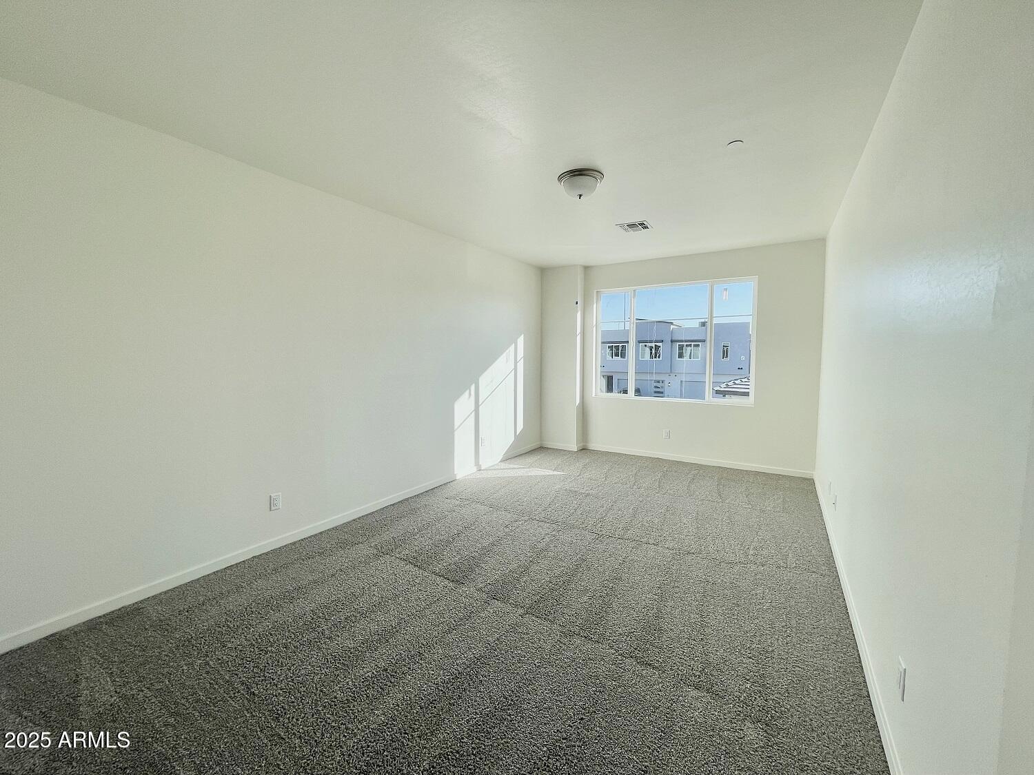 701 North McQueen Road, Unit 12 Chandler, AZ 85225 - Photo 5 of 15 an empty room with a empty space and windows