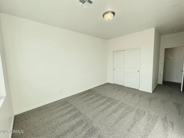 an empty room with a empty space and windows