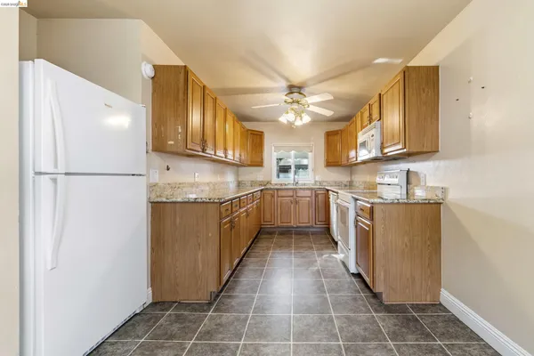 a kitchen with granite countertop cabinets sink and window