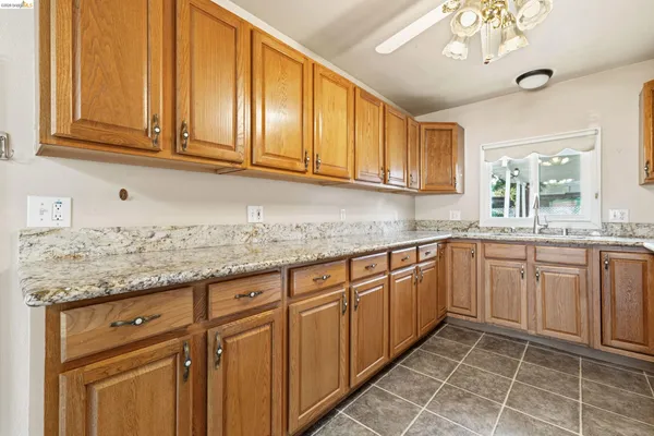 a kitchen with stainless steel appliances granite countertop a sink and cabinets
