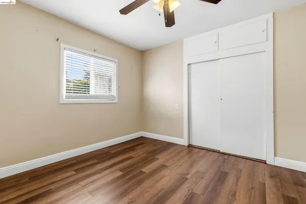 wooden floor in an empty room with a window