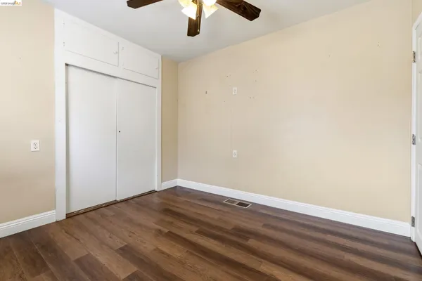 a bathroom with a granite countertop sink toilet a mirror and shower