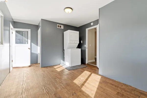 an empty room with windows and closet