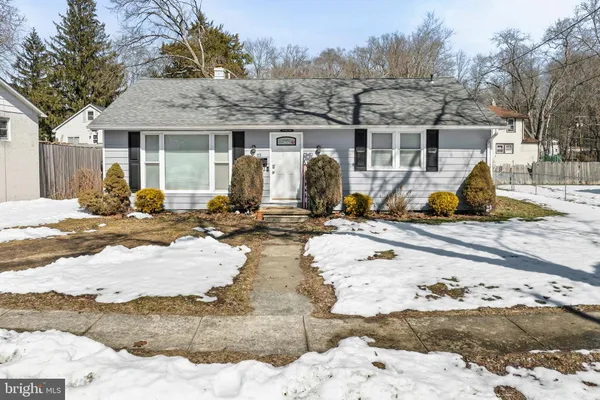 a view of a house with snow on the road