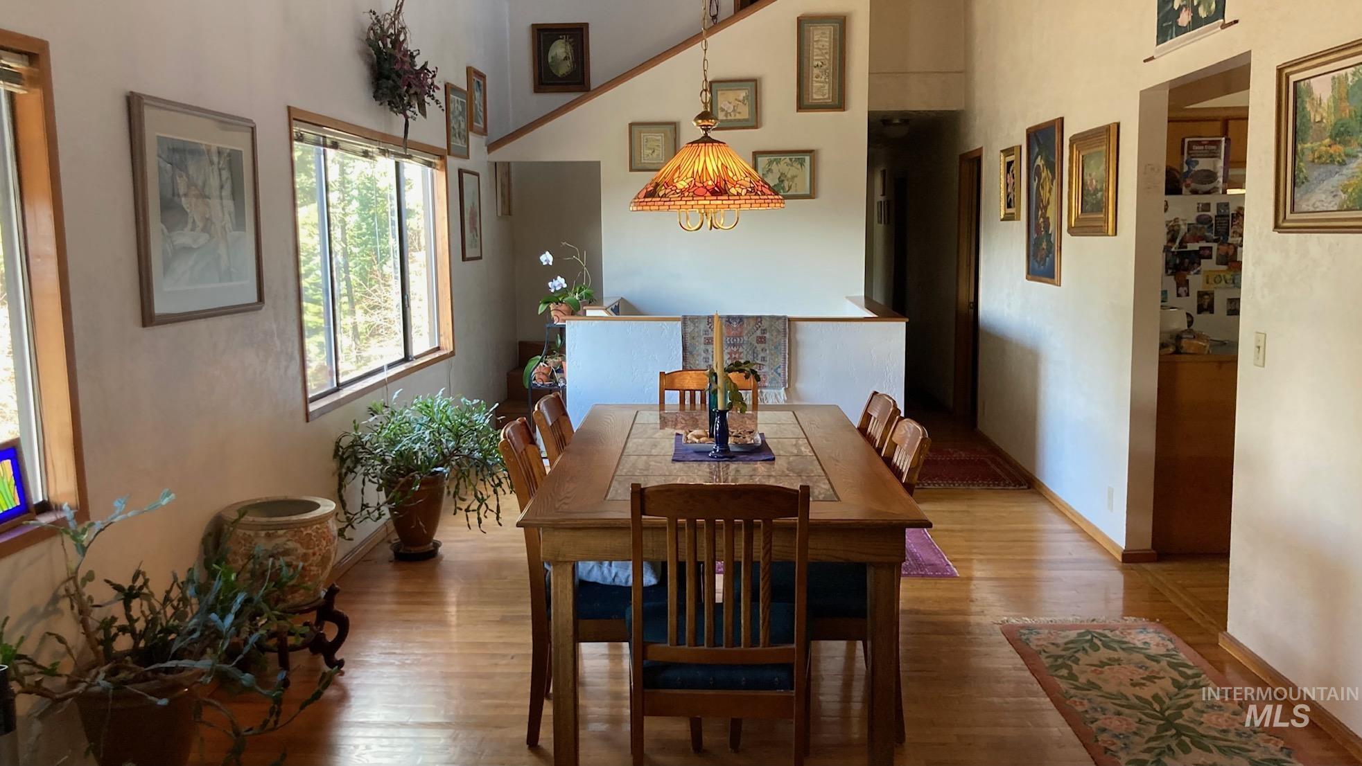 266 Falcon Ridge Road Kooskia, ID 83539 - Photo 8 of 50 Dining area featuring wood-finish flooring and a central chandelier
