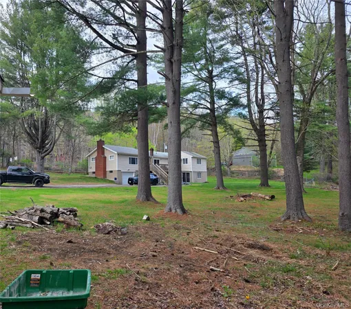 a view of a house with a yard and tree s