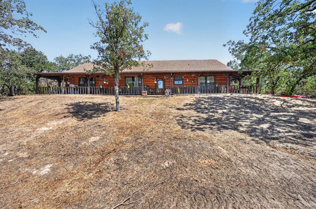 1623 3 Skillet Road Springtown, TX 76082 - Photo 1 of 40 Wood-sided exterior featuring a covered porch and a gabled roof