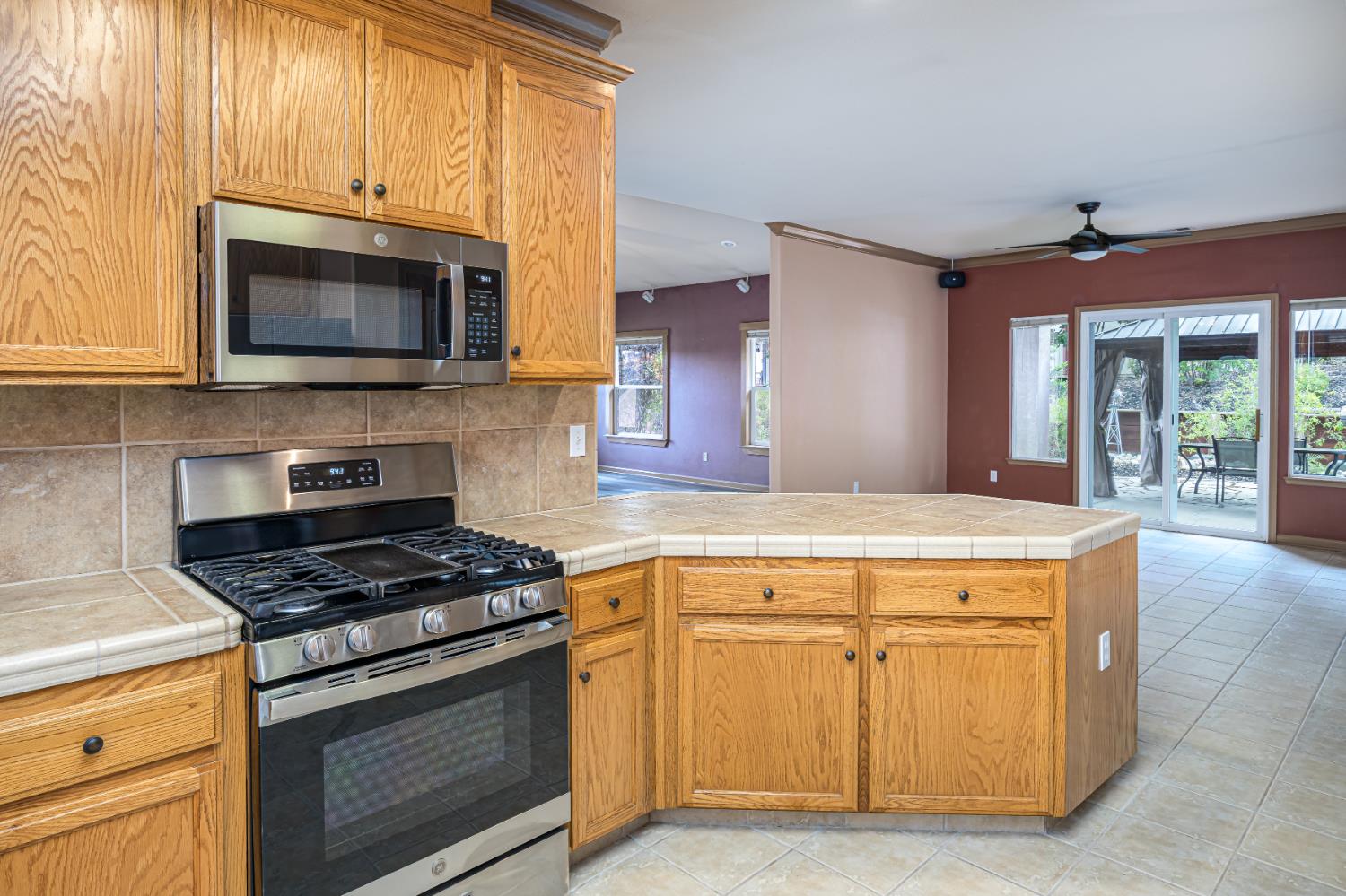 2083 State Rte 26 Valley Springs, CA 95252 - Photo 16 of 59 a kitchen with stainless steel appliances granite countertop a stove and a microwave