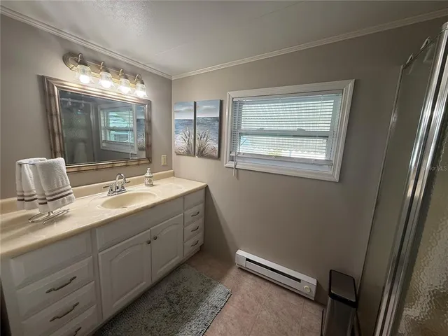 a bathroom with a double vanity sink toilet and a mirror