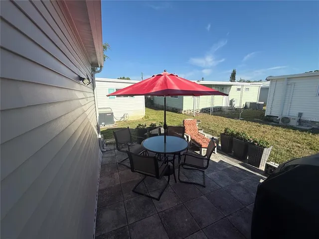 a view of a patio with furniture and a yard