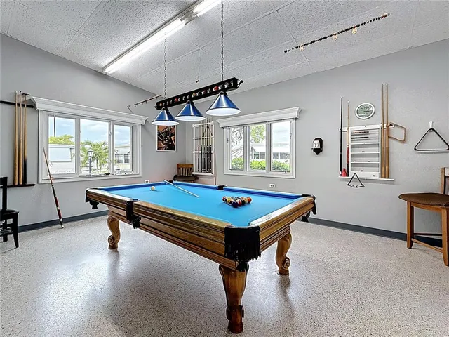 a room with pool table windows and windows