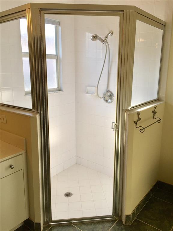 2498 Southwest Regency Road Stuart, FL 34997 - Photo 22 of 47 a bathroom with a glass shower door