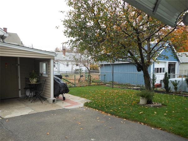 38-40 Jenness Street Springfield, MA 01104 - Photo 19 of 21 a view of a house with a yard and a large tree
