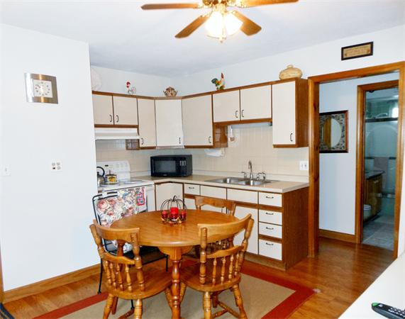 38-40 Jenness Street Springfield, MA 01104 - Photo 4 of 21 a kitchen with stainless steel appliances kitchen island granite countertop a dining table and chairs