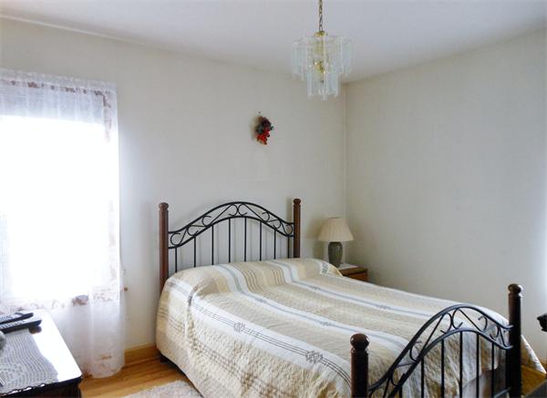 38-40 Jenness Street Springfield, MA 01104 - Photo 8 of 21 a bedroom with a bed and a chandelier