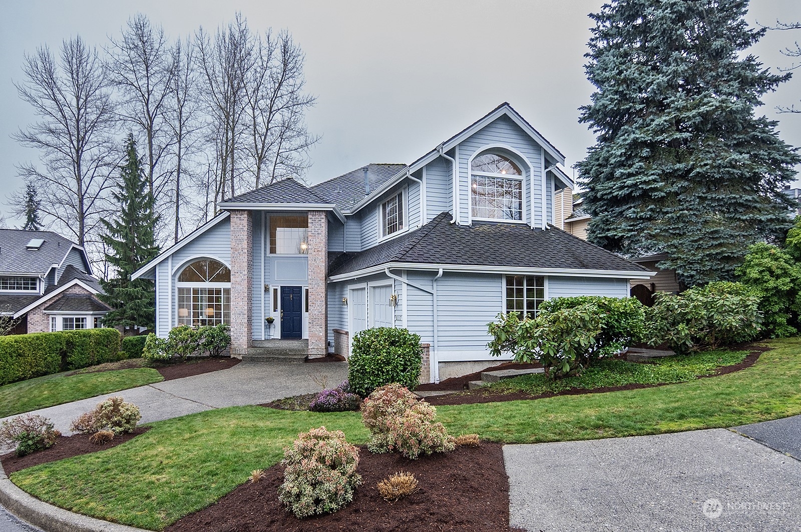 9117 Northeast 151st Street Bothell, WA 98011 - Photo 1 of 31 a front view of a house with a yard and garage