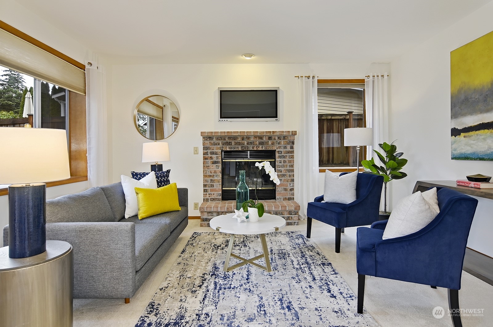 9117 Northeast 151st Street Bothell, WA 98011 - Photo 11 of 31 a living room with furniture fireplace and a flat screen tv