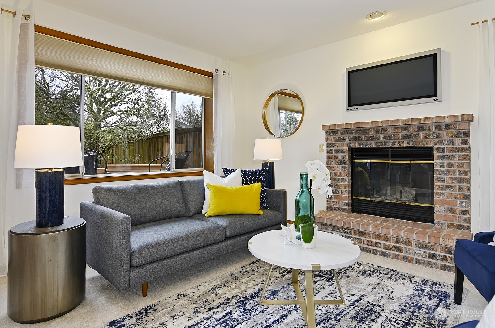 9117 Northeast 151st Street Bothell, WA 98011 - Photo 12 of 31 a living room with furniture a fireplace and a flat screen tv