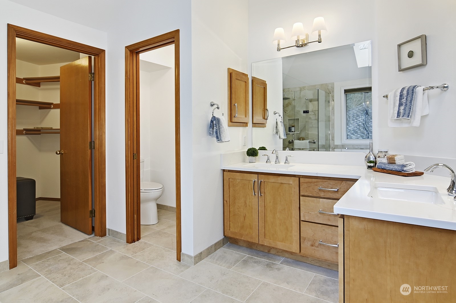 9117 Northeast 151st Street Bothell, WA 98011 - Photo 20 of 31 a spacious bathroom with a double vanity sink a mirror and a bathtub
