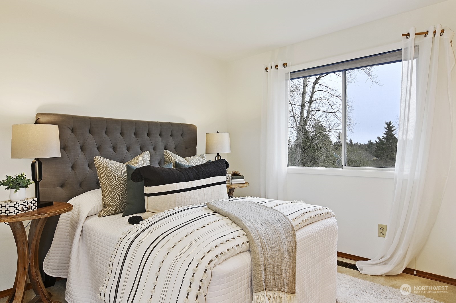 9117 Northeast 151st Street Bothell, WA 98011 - Photo 22 of 31 a bed sitting in a bedroom next to a window