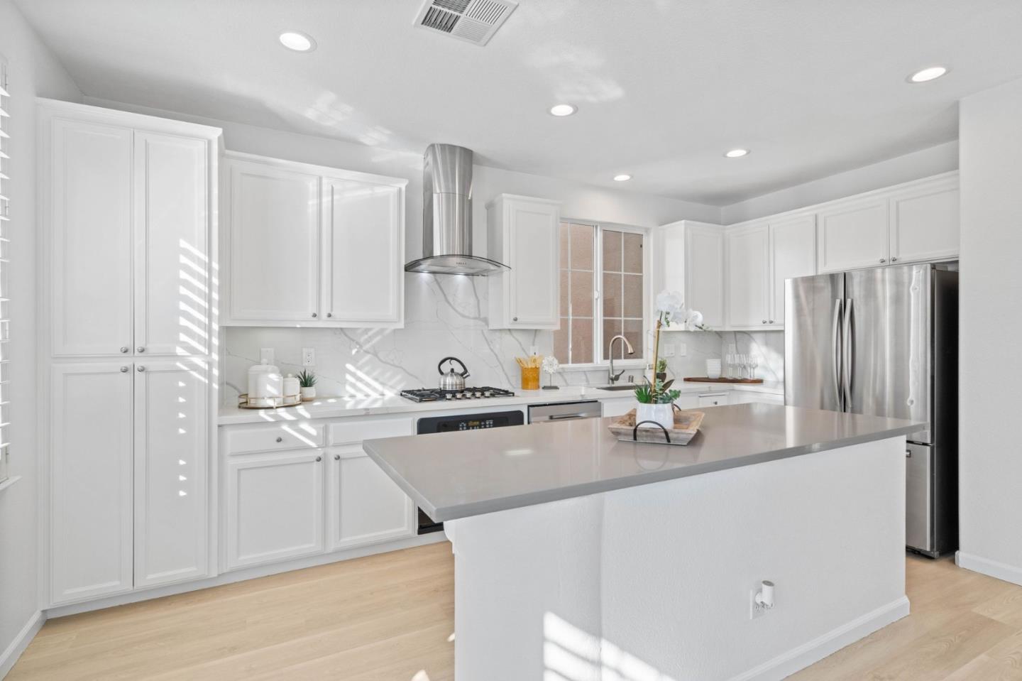 4203 Tobin Circle Santa Clara, CA 95054 - Photo 20 of 51 a kitchen with stainless steel appliances granite countertop a refrigerator a sink dishwasher a stove and white cabinets with wooden floor