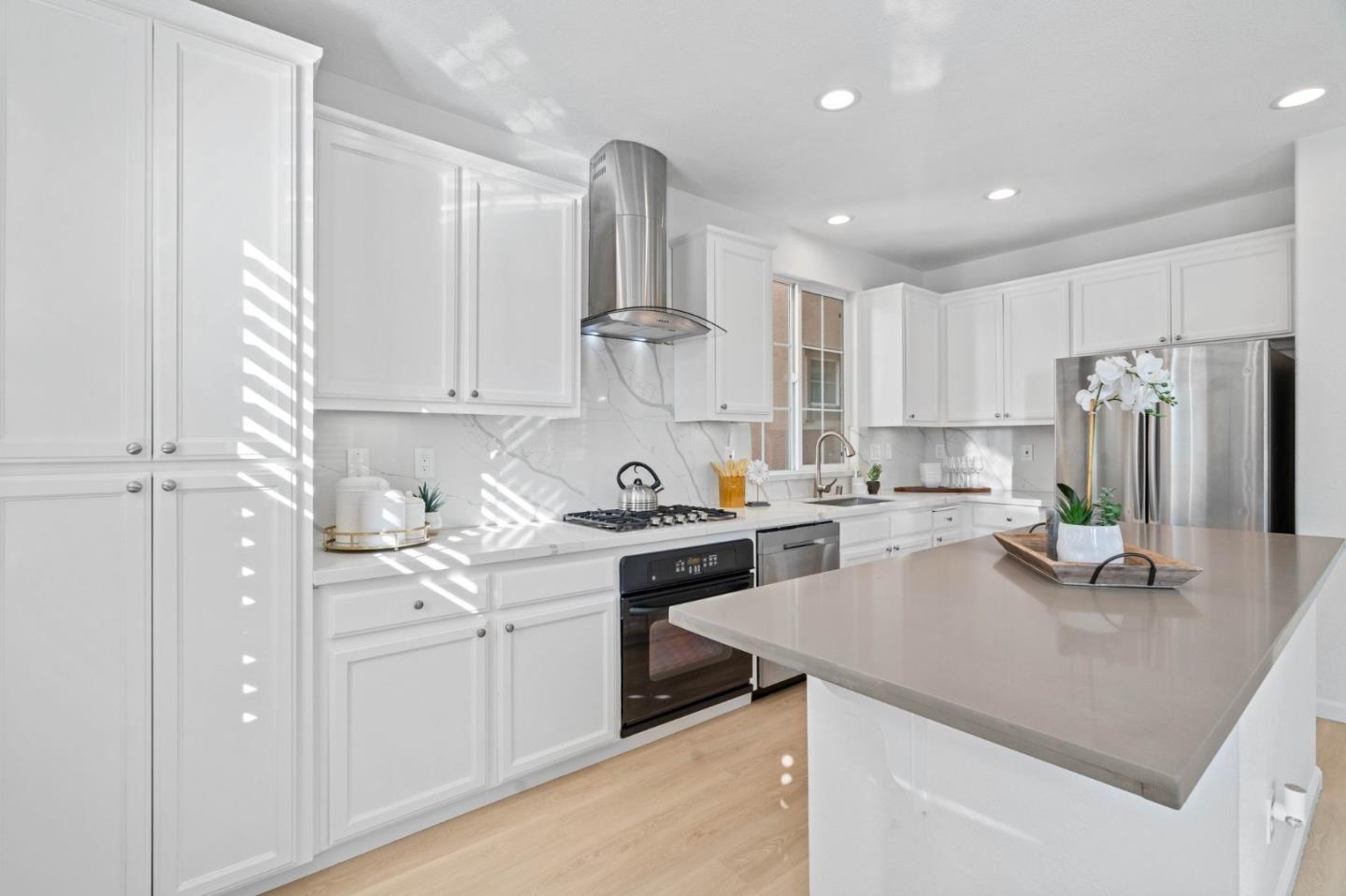4203 Tobin Circle Santa Clara, CA 95054 - Photo 21 of 51 a kitchen with a sink a stove a refrigerator and white cabinets