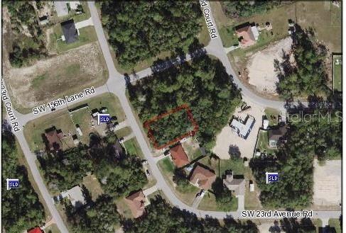 an aerial view of a house with a yard and garden
